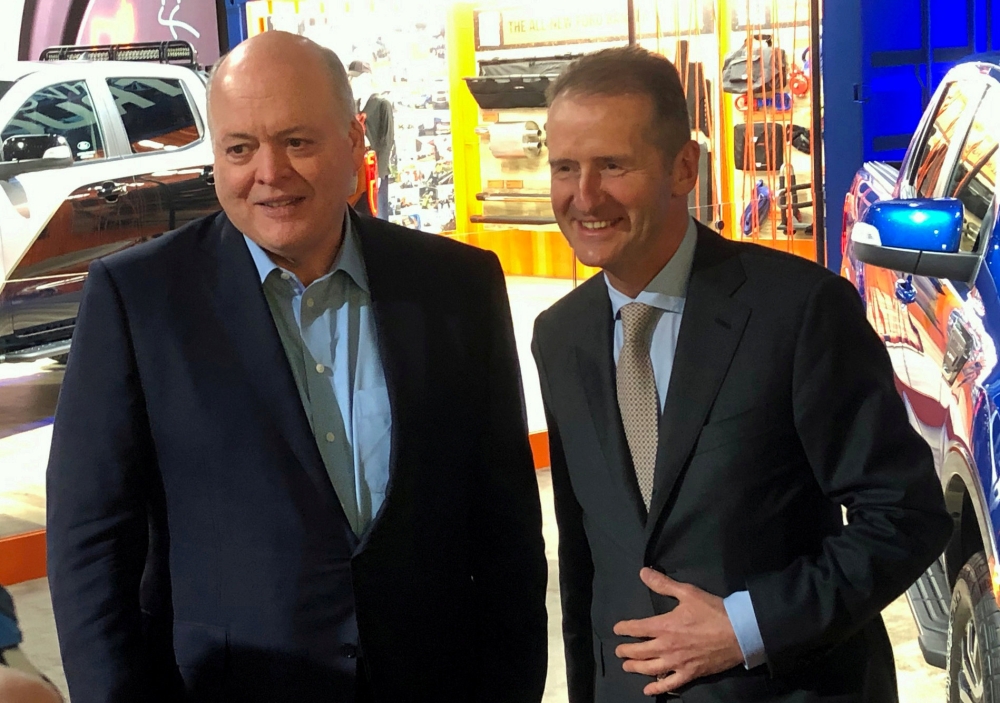 FILE PHOTO: The President and CEO of Ford Motor Company, Jim Hackett, poses with Volkswagen CEO Herbert Diess at the North American International Auto Show in Detroit, Michigan, U.S., January 14, 2019. REUTERS/Ben Klayman