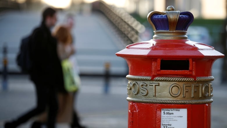 People walk past an ornate Royal Mail post box in Liverpool in 2016. (Phil Noble/Reuters)