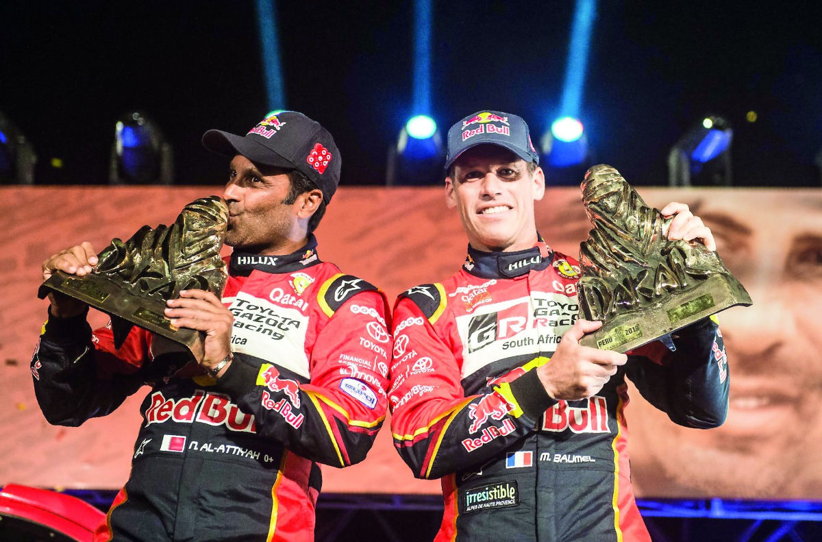 Qatari driver Nasser Saleh Al Attiyah (left) and co-driver Matthieu Baumel of France celebrate on the 2019 Dakar Rally podium in Lima, Peru, on Thursday. Al Attiyah cruised to his third Dakar Rally title with a 46-minute cushion over second-placed Nani Ro