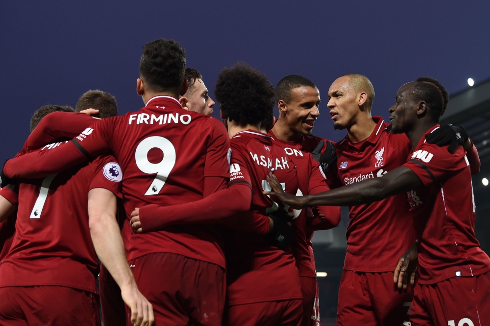 Liverpool's Egyptian midfielder Mohamed Salah (C) celebrates with teammates after scoring their third goal during the English Premier League football match between Liverpool and Crystal Palace at Anfield in Liverpool, north west England on January 19, 201