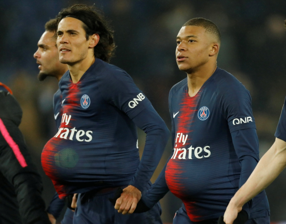 Paris St Germain's Edinson Cavani and Kylian Mbappe with match balls after the match REUTERS/Charles Platiau
