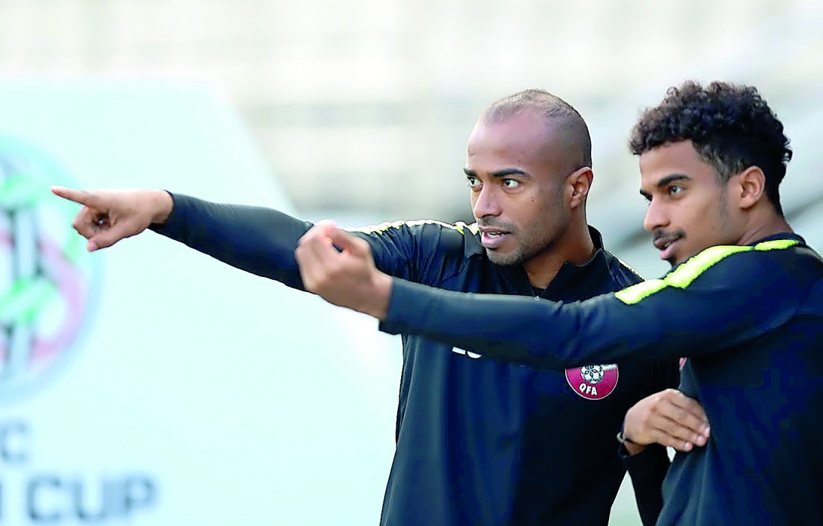 Qatar forward Akram Afif (right) and his team-mate Ali Hassan Afif during the training session, yesterday.   