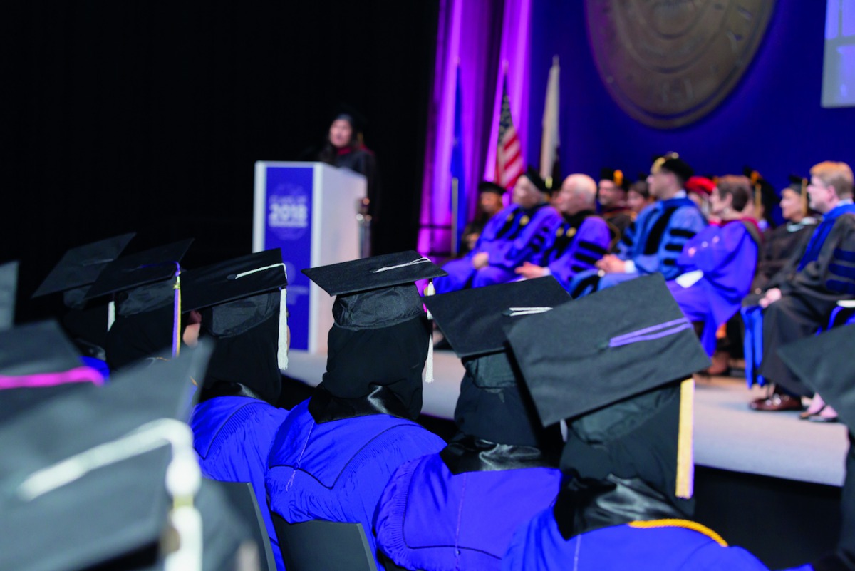 NU-Q students and dignitaries during a graduation ceremony.
