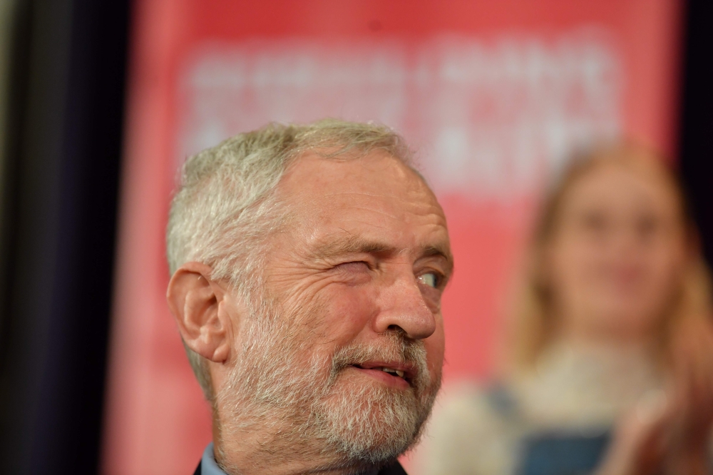 Britain's opposition Labour party leader Jeremy Corbyn winks to a colleague as he attends a political rally event in Hastings, southeast England on January 17, 2019. AFP / Ben STANSALL