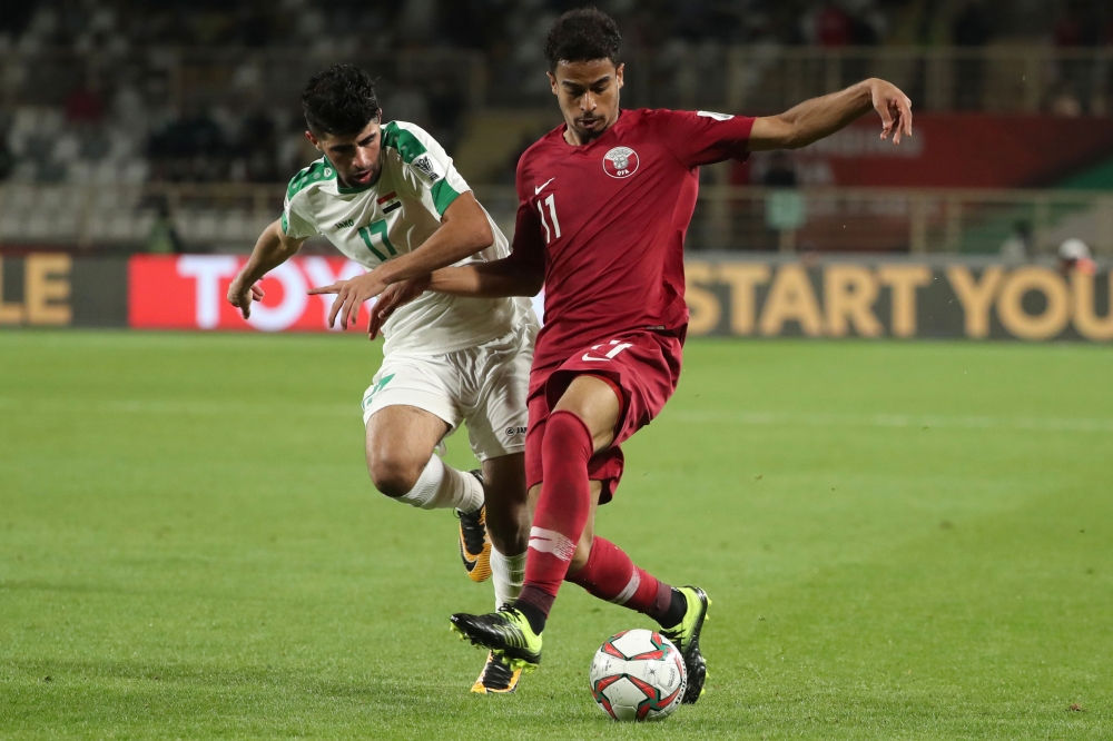 Qatar's forward Akram Afif (R) is marked by Iraq's defender Alaa Ali Mhawi during the 2019 AFC Asian Cup Round of 16 football match between Qatar and Iraq at the Al Nahyan Stadium in Abu Dhabi on January 22, 2019. / AFP / Karim Sahib