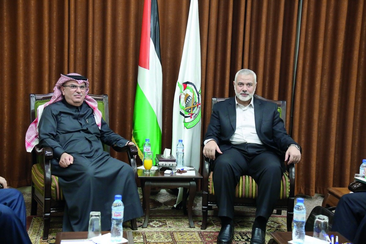 Hamas Chief Ismail Haniyah (right), meets with Qatari envoy Mohammed Al Emadi in Gaza City, yesterday.