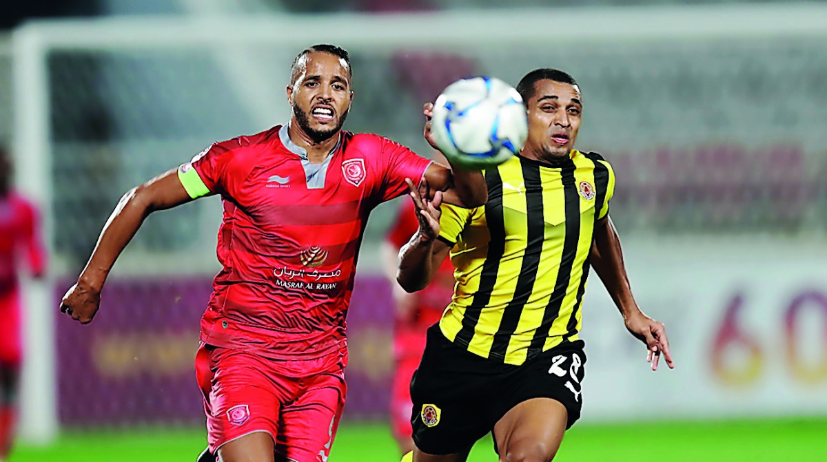 Al Duhail’s Youssef El Arabi (left) and Qatar SC’s Sandro Ferreira Nascimento chase the ball during yesterday’s  semi-final. 