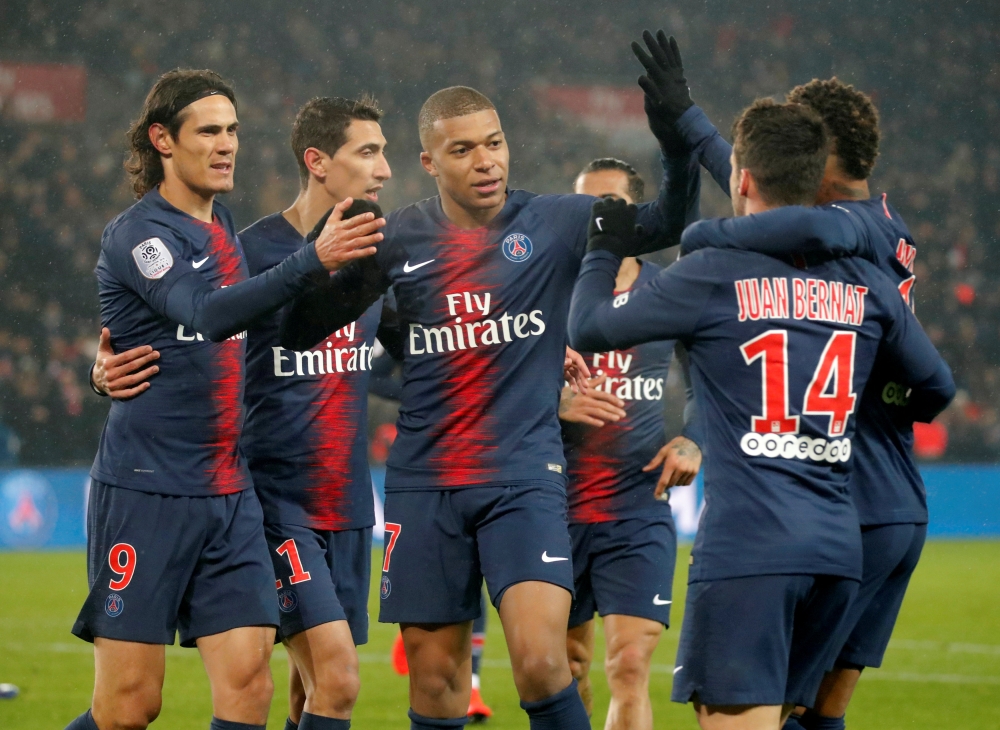 FILE PHOTO: Paris St Germain's Edinson Cavani celebrates scoring their fourth goal with team mates REUTERS/Charles Platiau

