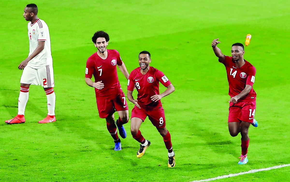 Hamid Ismail (second right) celebrates after scoring Qatar’s fourth goal with team-mates during the Asian Cup semi-final match against UAE in Abu Dhabi yesterday.