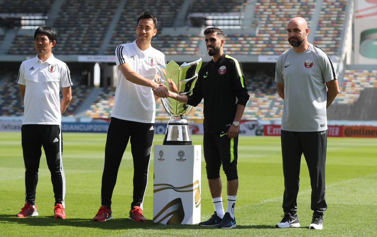 Japan’s Maya Yoshida (left) and head coach Hajime Moriyasu (second left) pose with Qatari captain Hassan Al Haydos (second right) and head coach Felix Sanchez during a photo session at the Zayed Sports City Stadium in Abu Dhabi, yesterday.