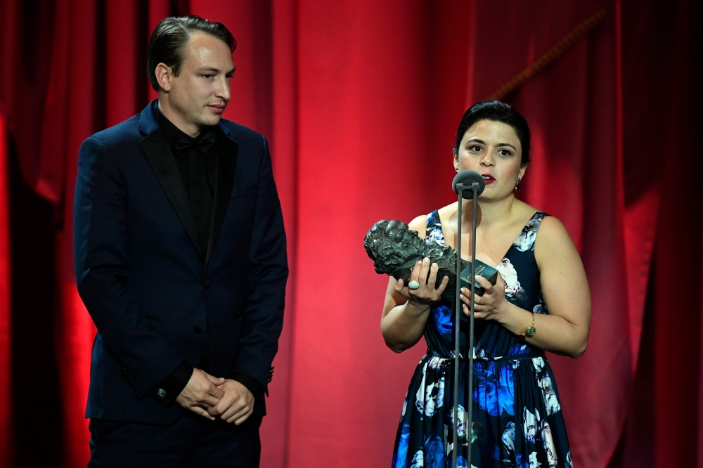 Film producers Gabriela Rodriguez (R) and Nicolas Celis receive the best Latin-American film award for the Mexican film 'Roma' at the 33rd Goya awards ceremony in Seville on February 2, 2019. / AFP / JAVIER SORIANO