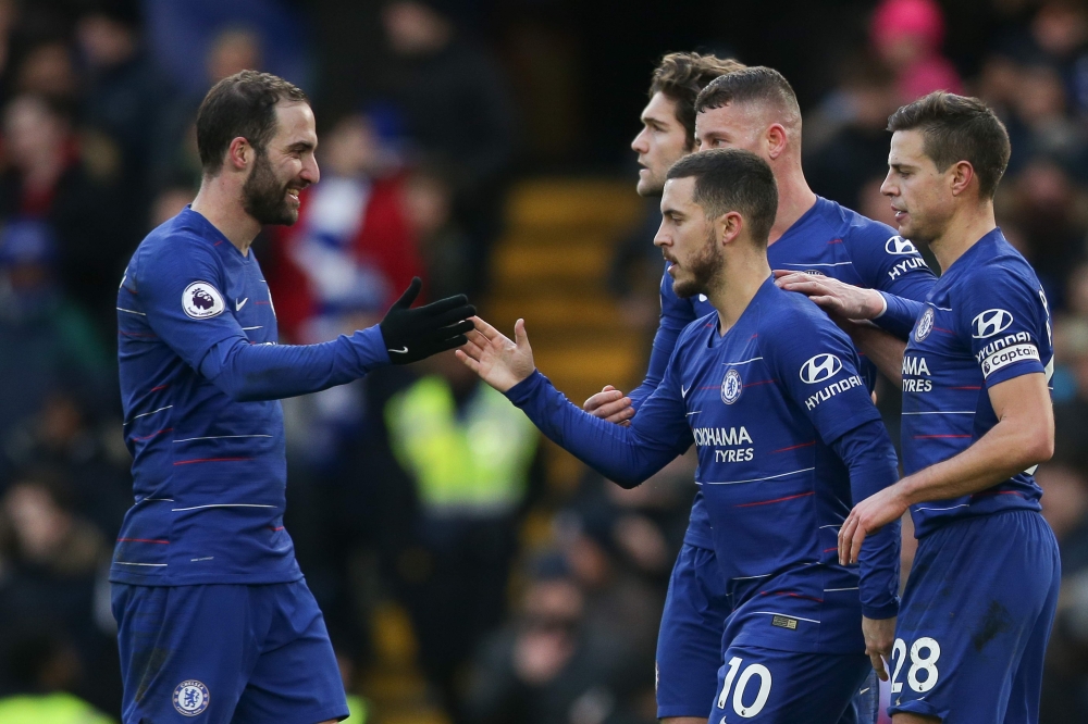 Chelsea's Belgian midfielder Eden Hazard (C) celebrates scoring their second goal from the penalty spot during the English Premier League football match between Chelsea and Huddersfield Town at Stamford Bridge in London on February 2, 2019. AFP / Daniel L