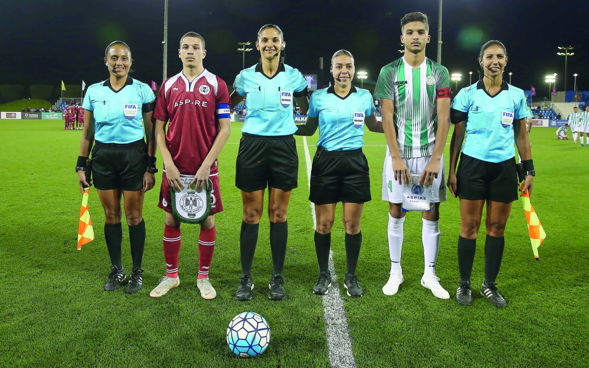 Women FIFA referees pose for a picture with captains of Aspire Academy and Raja Casablanca of Morocco before the Al Kass Cup match at Aspire Academy on Monday. 