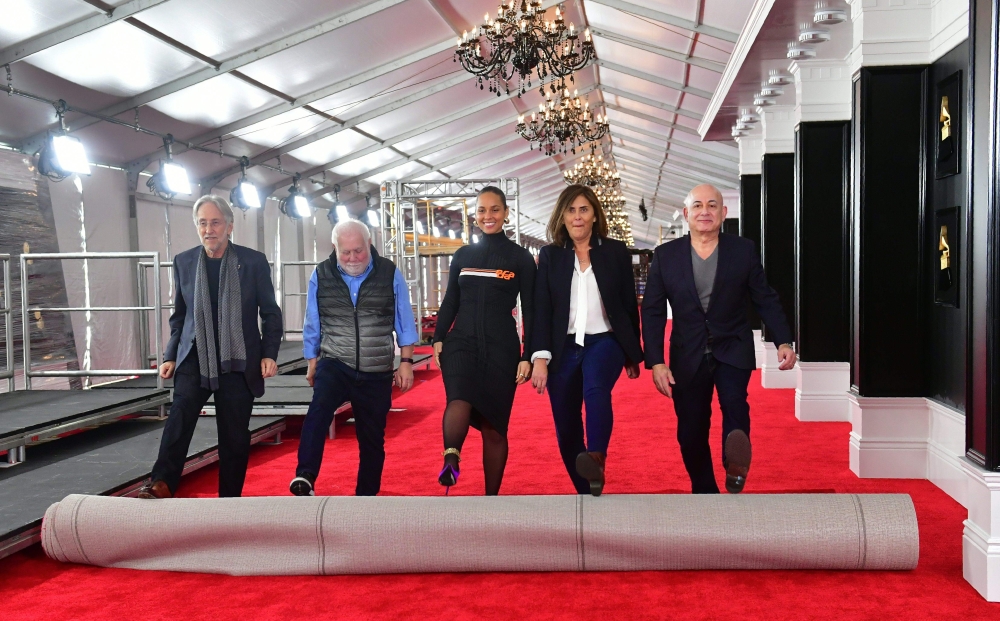 Fifteen-time Grammy winner Alicia Keys (C) joins Neil Portnow (L), Ken Ehrlich (2ndL) Chantal Saucedo (2ndR) and Jack Sussman (R) in the unrolling of the Red Carpet on February 7, 2019 in Los Angeles, California for the 61st Grammy Awards to be held here 