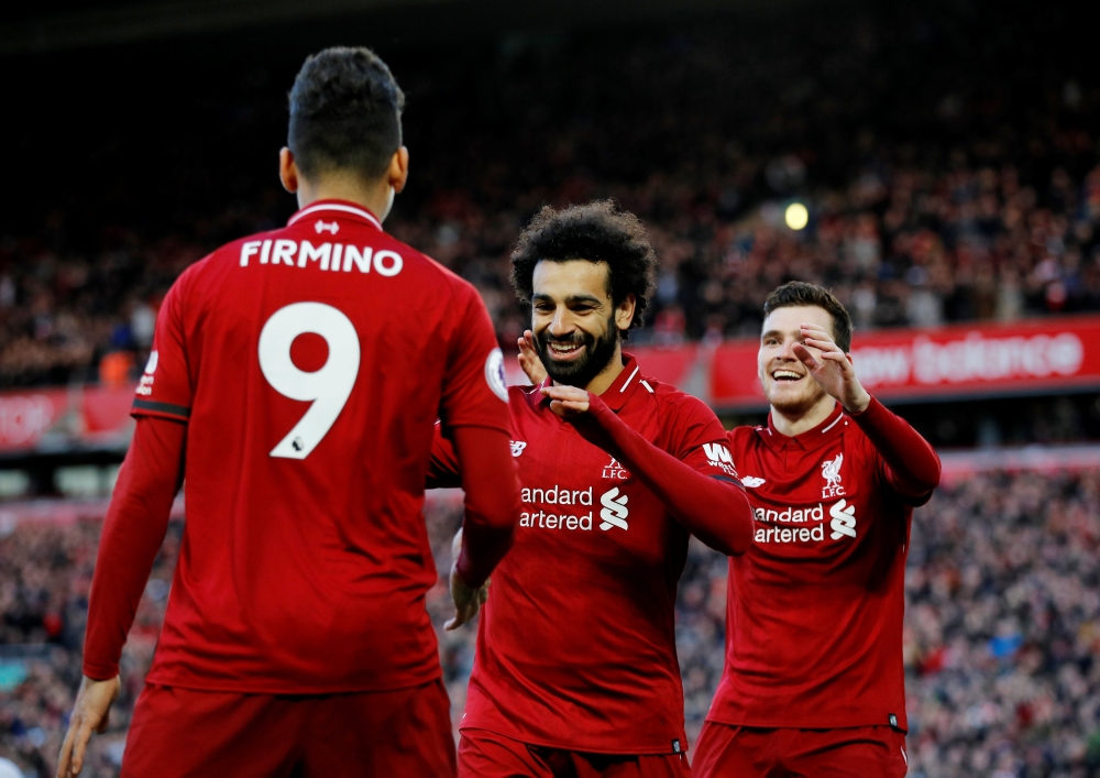 Liverpool's Mohamed Salah celebrates scoring their third goal with Roberto Firmino and Andrew Robertson REUTERS/Phil Noble 