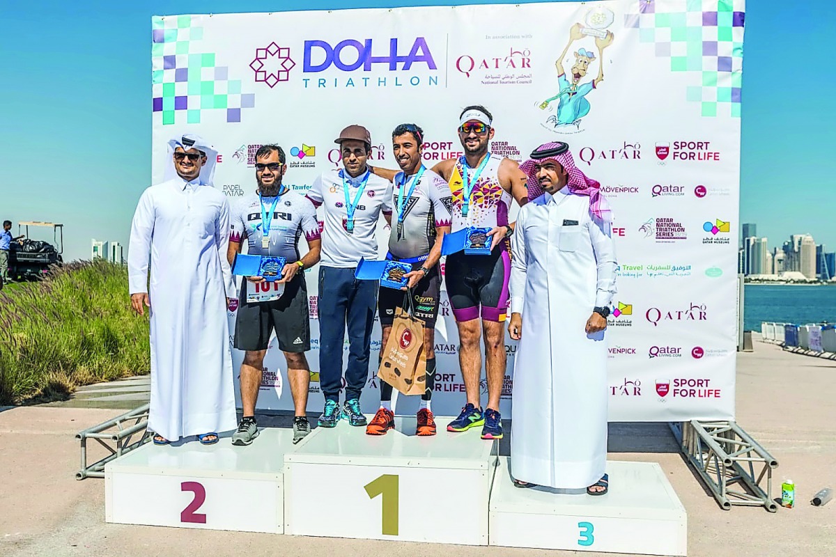 The Podium winners pose for a photograph with officials during the presentation ceremony at the end of the Doha Triathlon on Friday. 