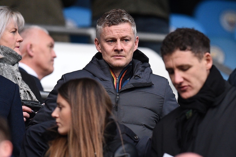 Manchester United's Norwegian caretaker manager Ole Gunnar Solskjaer (C) waits in the stands ahead of the English Premier League football match between Manchester City and Burnley at the Etihad Stadium in Manchester, north west England, on February 10, 20