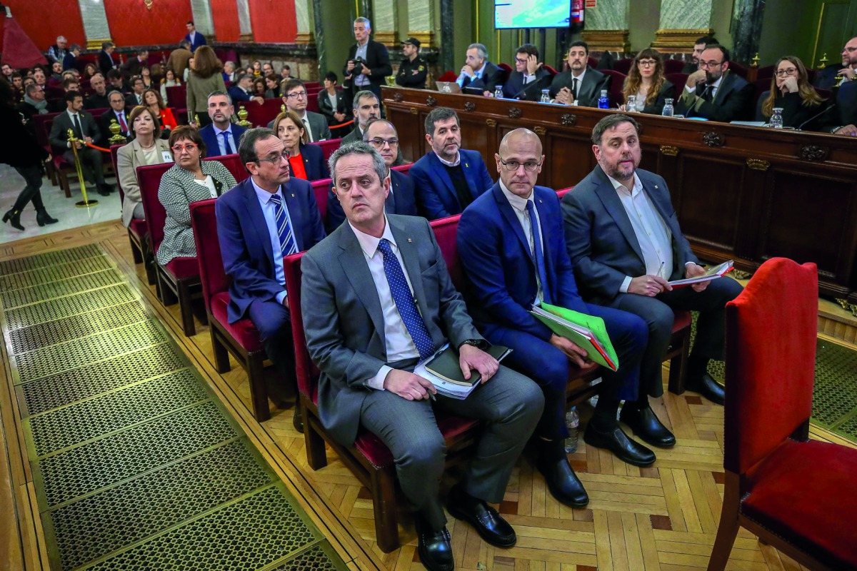 Former Catalan separatist leaders including (from front row R-L) Oriol Junqueras, Raul Romeva, Joaquim Forn, Jordi Sanchez, Jordi Turull, Josep Rull, Jordi Cuixart, Carme Forcadell, Dolors Bassa, Carles Mundo, Santi Vila and Meritxel Borras attend their t