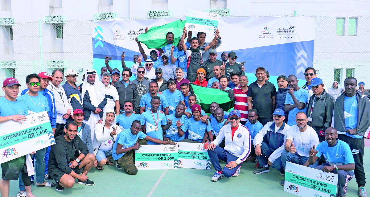 Karwa employees pose for a group photo with Mowasalat officials after taking part in NSD activities. 