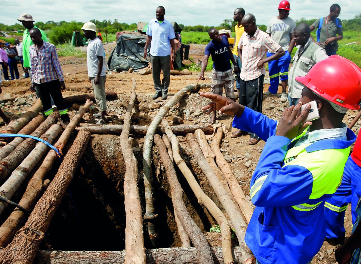 People gather over a shaft as retrieval efforts proceed for trapped illegal gold miners in Kadoma, Zimbabwe, February 15, 2019. Reuters/Philimon Bulawayo