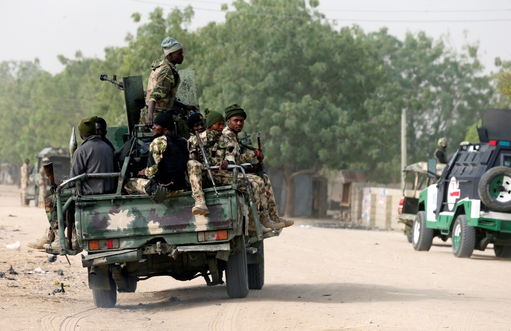 Nigerian military ride on their truck as they secure the area where a man was killed by suspected militants during an attack around Polo area of Maiduguri, Nigeria February 16, 2019. REUTERS/Afolabi Sotunde