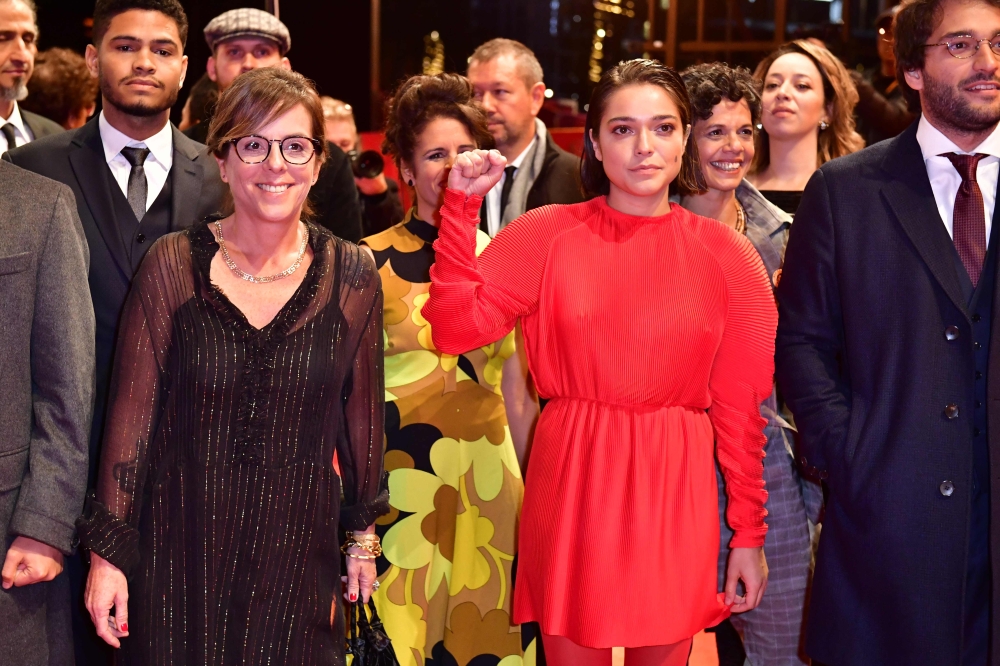 Brazilian actress Bella Camero and members of the casting crew pose on the red carpet before the premiere of the film 