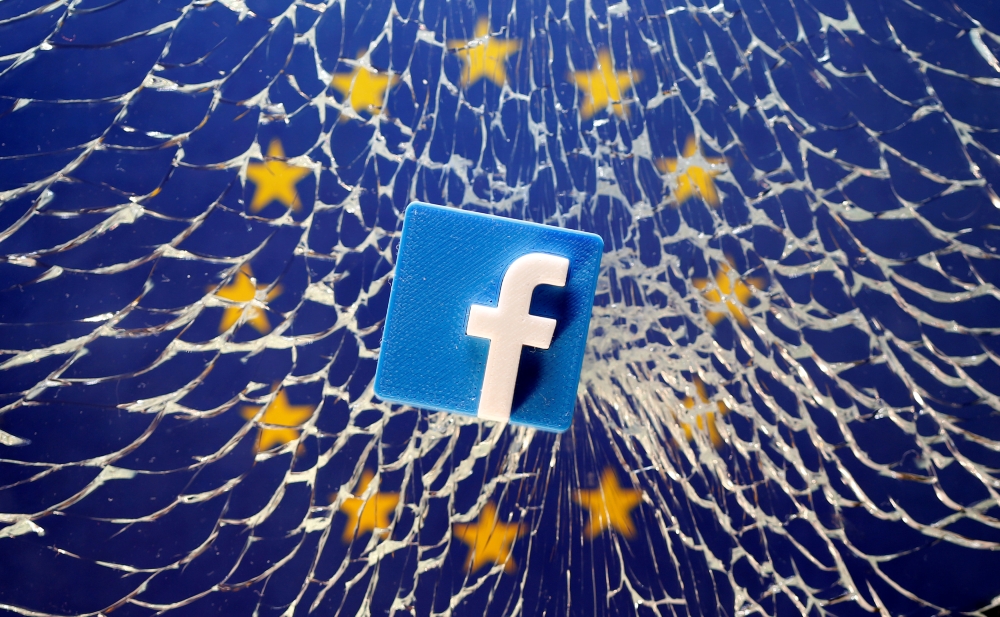 FILE PHOTO: A 3D printed Facebook logo is placed on broken glass above a printed EU flag in this illustration taken January 28, 2019. REUTERS/Dado Ruvic/File Photo