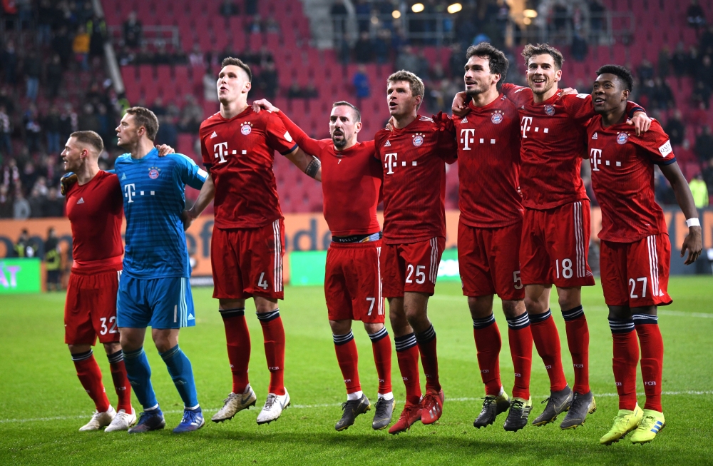 Bayern Munich players celebrate in front of the fans at the end of the match REUTERS/Andreas Gebert