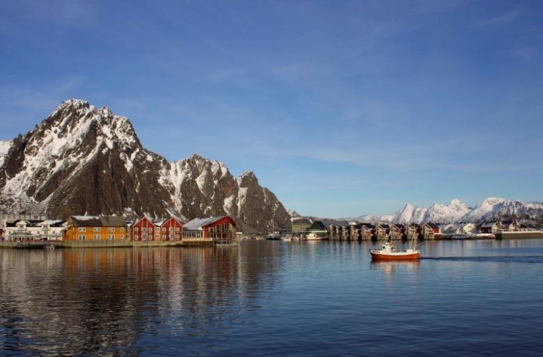 A fishing boat enters the harbour at the Arctic port of Svolvaer in northern Norway, March 4, 2013. Reuters/Alister Doyle