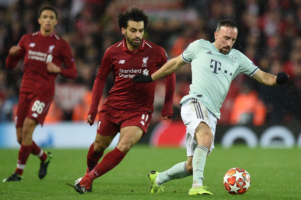 Bayern Munich midfielder Franck Ribery vies with Liverpool midfielder Mohamed Salah during the UEFA Champions League round of 16 first leg football match at Anfield stadium in Liverpool, north-west England on February 19, 2019.  AFP / Oli Scarff.