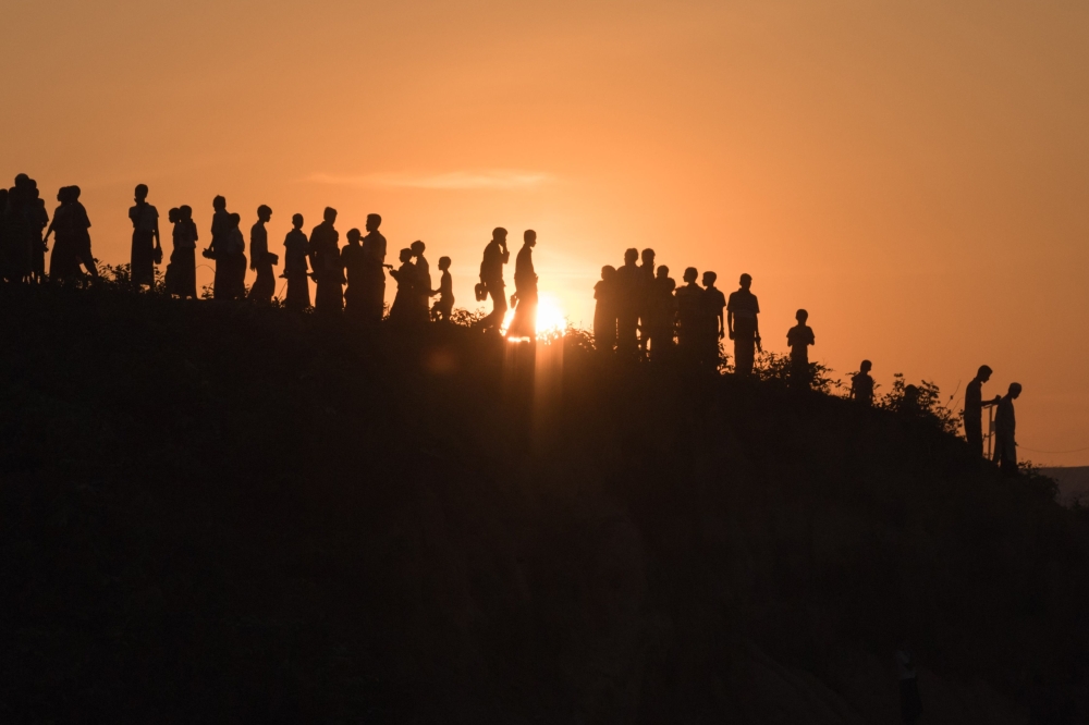In this file photo taken on November 26, 2017, Rohingya Muslim refugees walk down a hillside in the Kutupalong refugee camp in Bangladesh. AFP/Ed Jones