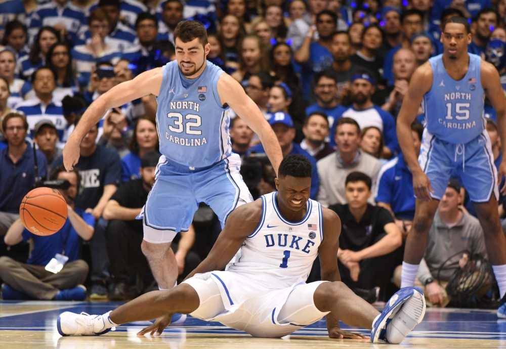 Duke Blue Devils forward Zion Williamson (1) reacts after falling while driving to the basket as North Carolina Tar Heels forward Luke Maye (32) defends during the first half at Cameron Indoor Stadium. Rob Kinnan-USA TODAY Sports