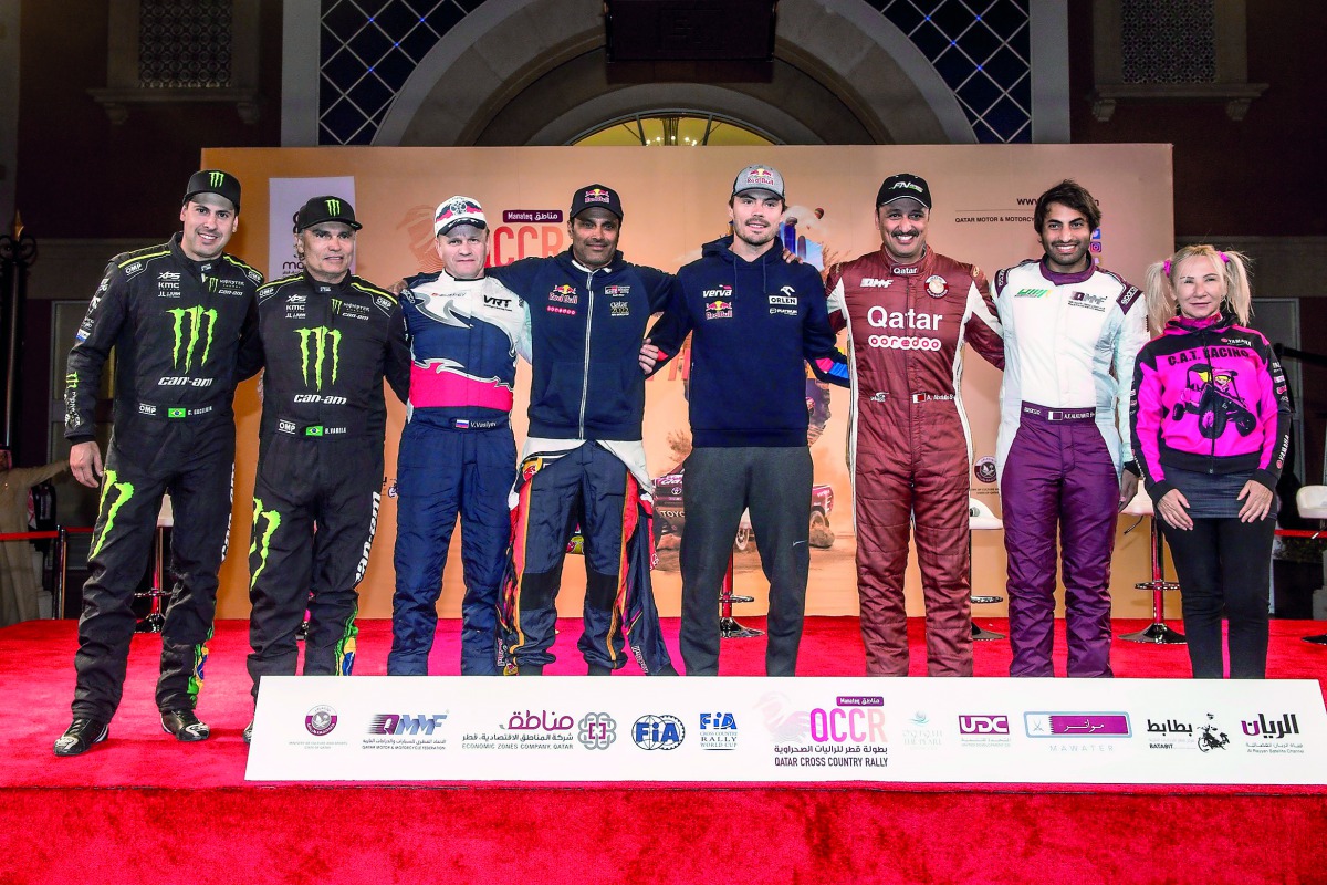 Qatari drivers Nasser Saleh Al Attiyah, Adel Abdulla and Ahmed Al Kuwari pose for a photograph with the defending FIA World Cup champion Jakub Przygonski, Camelia Liparoti, Vladimir Vasilyev and Reinaldo Varela prior to the ceremonial start of the Manateq