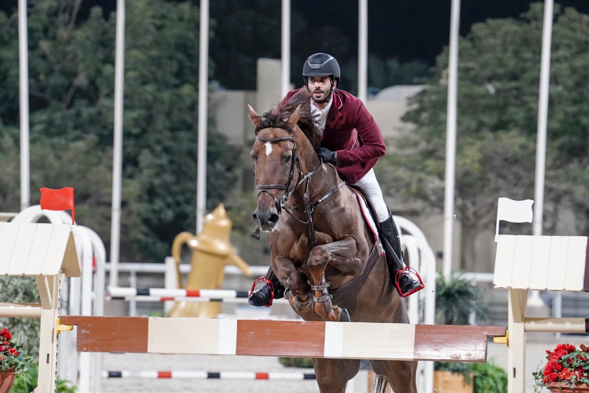 Mubarak Al Rumaihi guides Vivaldi K  over an obstacle on his way to win the Big Tour class during the Amir’s Golden Sword Championships at the Outdoor Arena of the Qatar Equestrian Federation, yesterday.