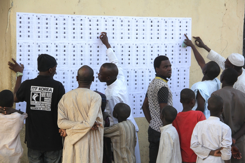 Voters check their names on the lists to vote in Maiduguri on February 23, 2019.  AFP / AUDU ALI MARTE
