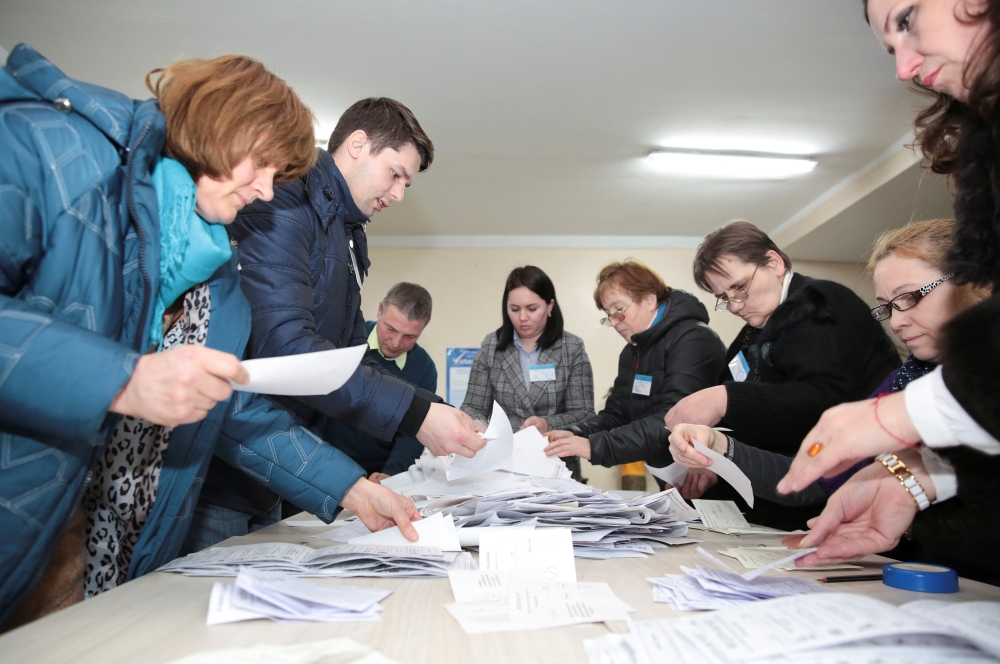 Members of a local electoral commission count votes following a parliamentary election in Chisinau, Moldova February 24, 2019. REUTERS/Vladislav Culiomza