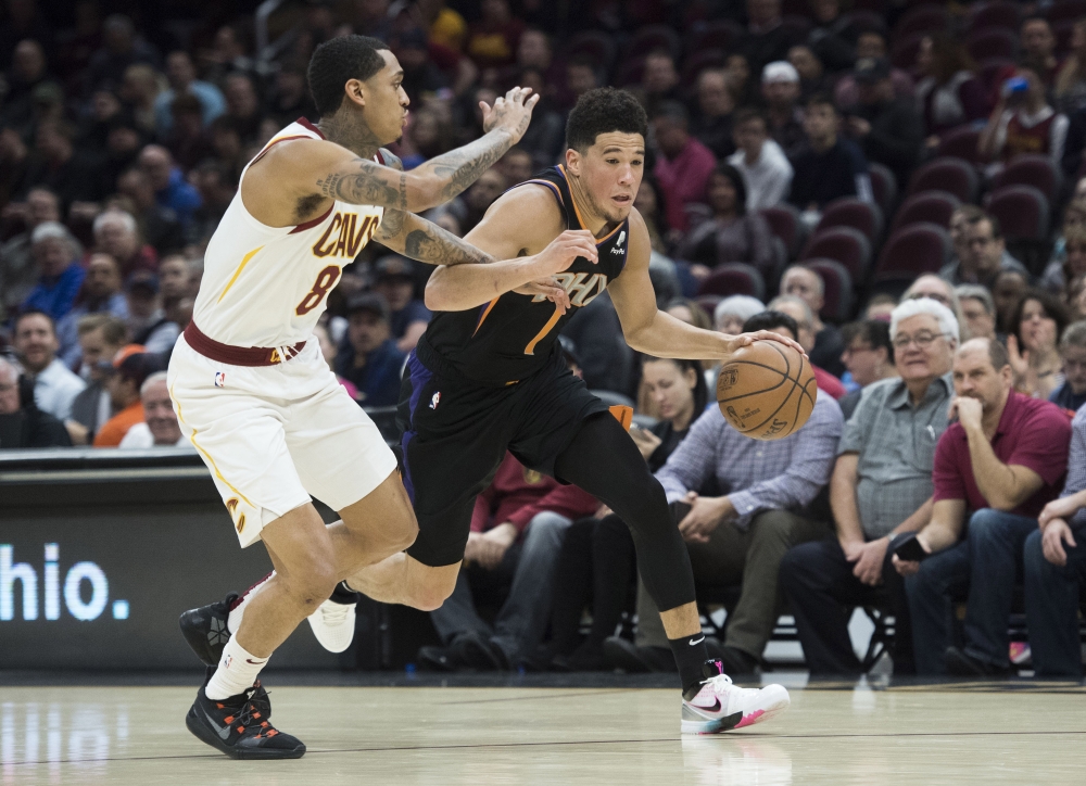 Phoenix Suns guard Devin Booker (1) drives to the basket against Cleveland Cavaliers guard Jordan Clarkson (8) during the first half at Quicken Loans Arena Feb 21, 2019; Cleveland.  Credit: Ken Blaze-USA TODAY Sports