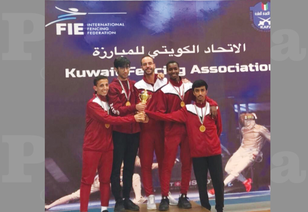 Qatari fencers pose for a photograph with their medals and trophies during the Arab Fencing Championship in Kuwait.