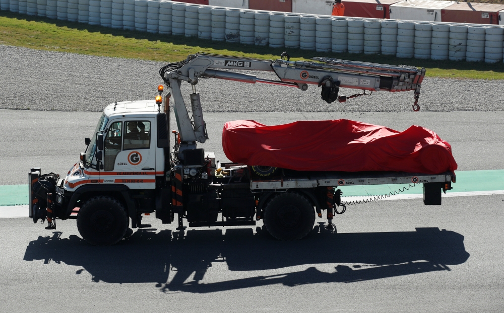 The car of Ferrari's Sebastian Vettel is taken off the track after a crash during testing REUTERS/Albert Gea