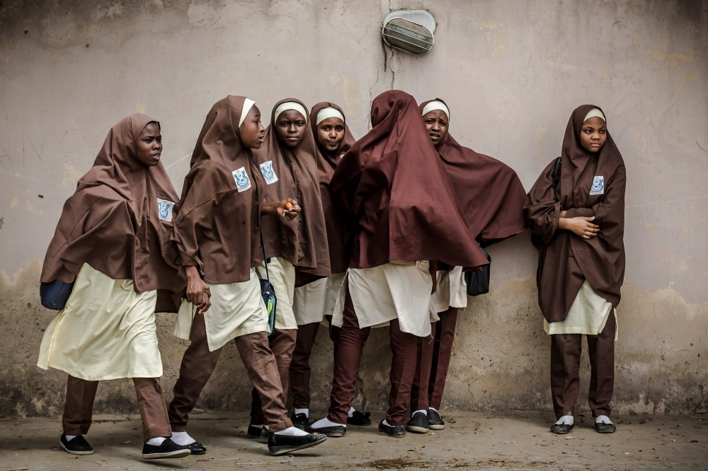A group of girls leave their school during a rally by All Progressives Congress (APC) party supporters celebrating the re-election of the incumbent president and the leader of APC, in Kano on February 27, 2019.  AFP / Luis Tato 
 