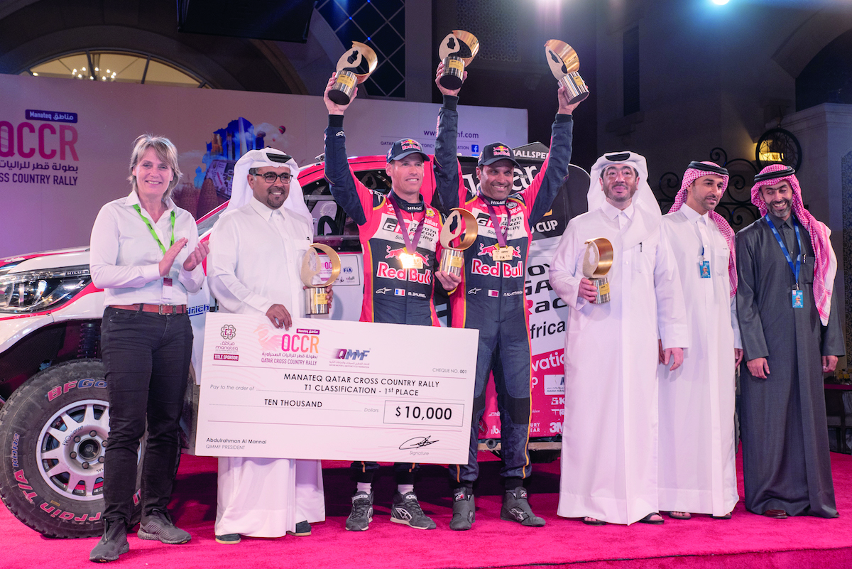 Qatar Motor and Motorcycle Federation President Abdulrahman Al Mannai, Manateq CEO Fahad Al Kaabi and officials pose for a photograph with Al Attiyah and Matthieu Baumel during the presentation ceremony on Tuesday.