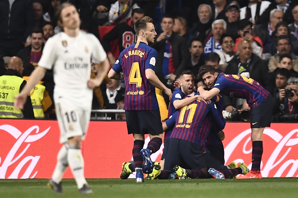 Barcelona players celebrate their opening goal during the Spanish Copa del Rey (King's Cup) semi-final second leg football match between Real Madrid and Barcelona at the Santiago Bernabeu stadium in Madrid on February 27, 2019. / AFP / OSCAR DEL POZO