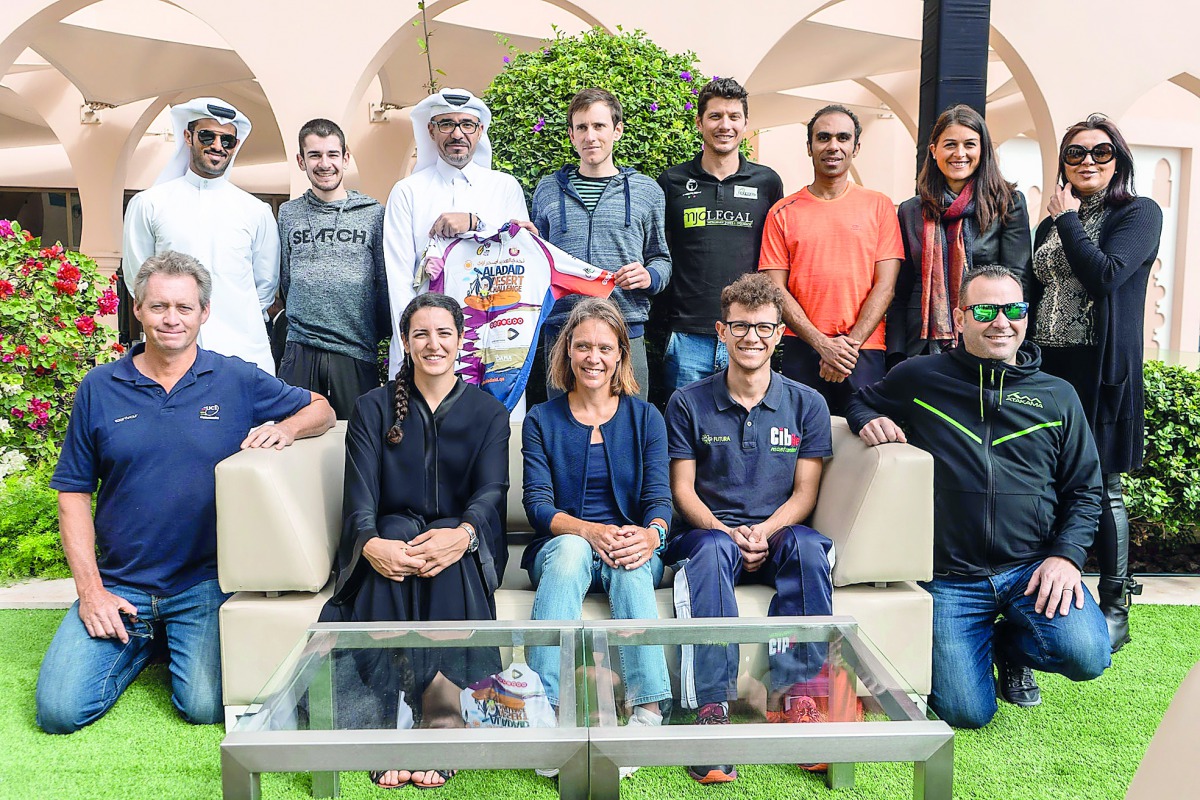 Dr. Jamal Rashid Al Khanji, Managing Director of Al Adaid Desert Challenge, poses for a photograph with the elite athletes who will be in action during today’s event.
