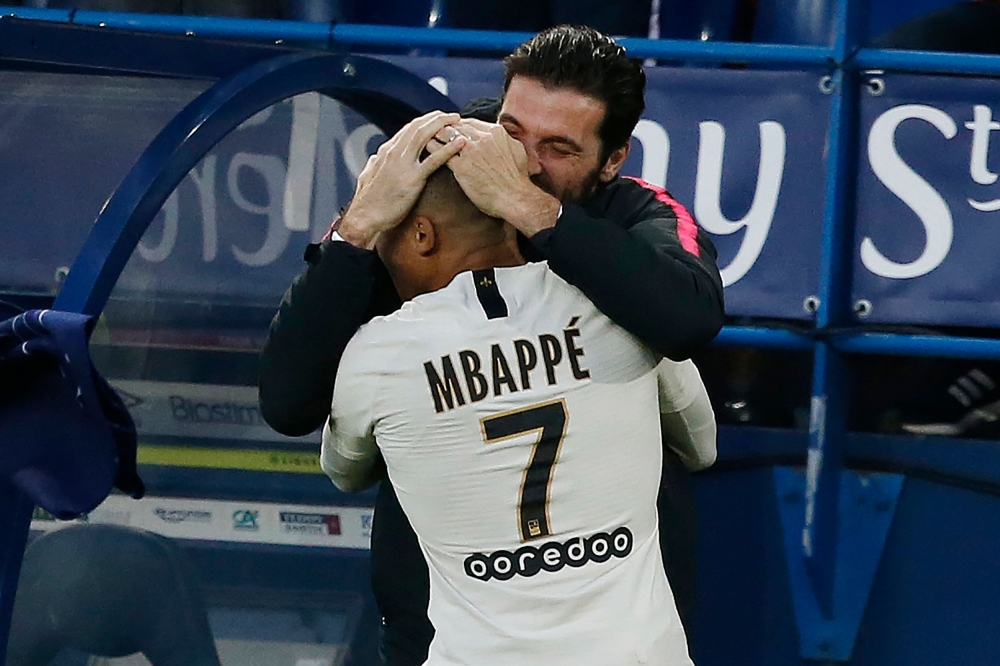 Paris Saint-Germain's French forward Kylian Mbappe (L) celebrates with Paris Saint-Germain's Italian goalkeeper Gianluigi Buffon after scoring a goal during the French L1 football match between Caen (SMC) and Paris Saint-Germain (PSG) at the Michel d'Orna