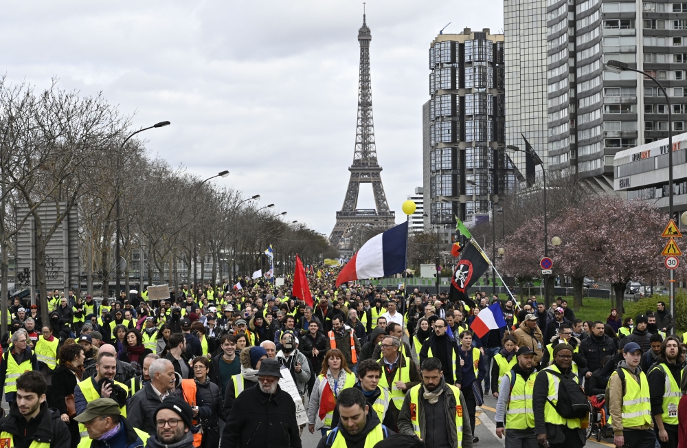 French yellow vests (Gilets jaunes) protesters walk near the Eiffel Tower during the 'Act XVI' demonstration (the 16th consecutive Saturday national protest) in Paris, France on March 2, 2019. Mustafa Yalç?n - Anadolu