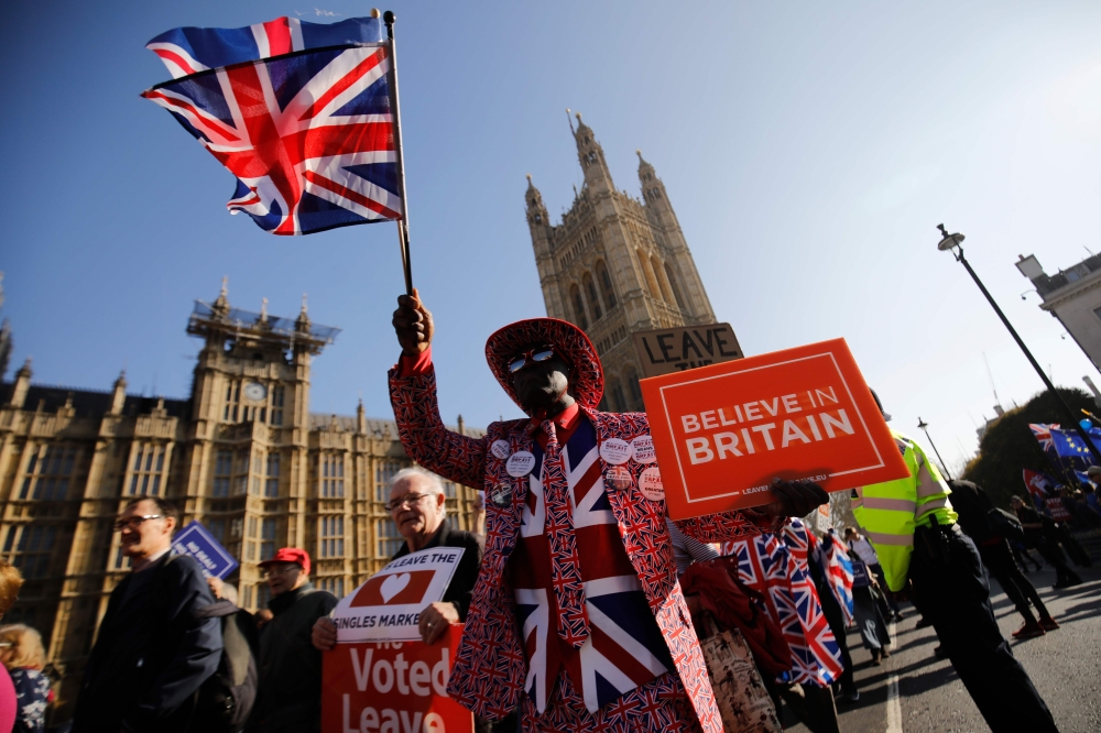 (FILES) In this file photo taken on February 27, 2019, pro-Brexit activists march outside the Houses of Parliament in central London. AFP / Tolga AKMEN