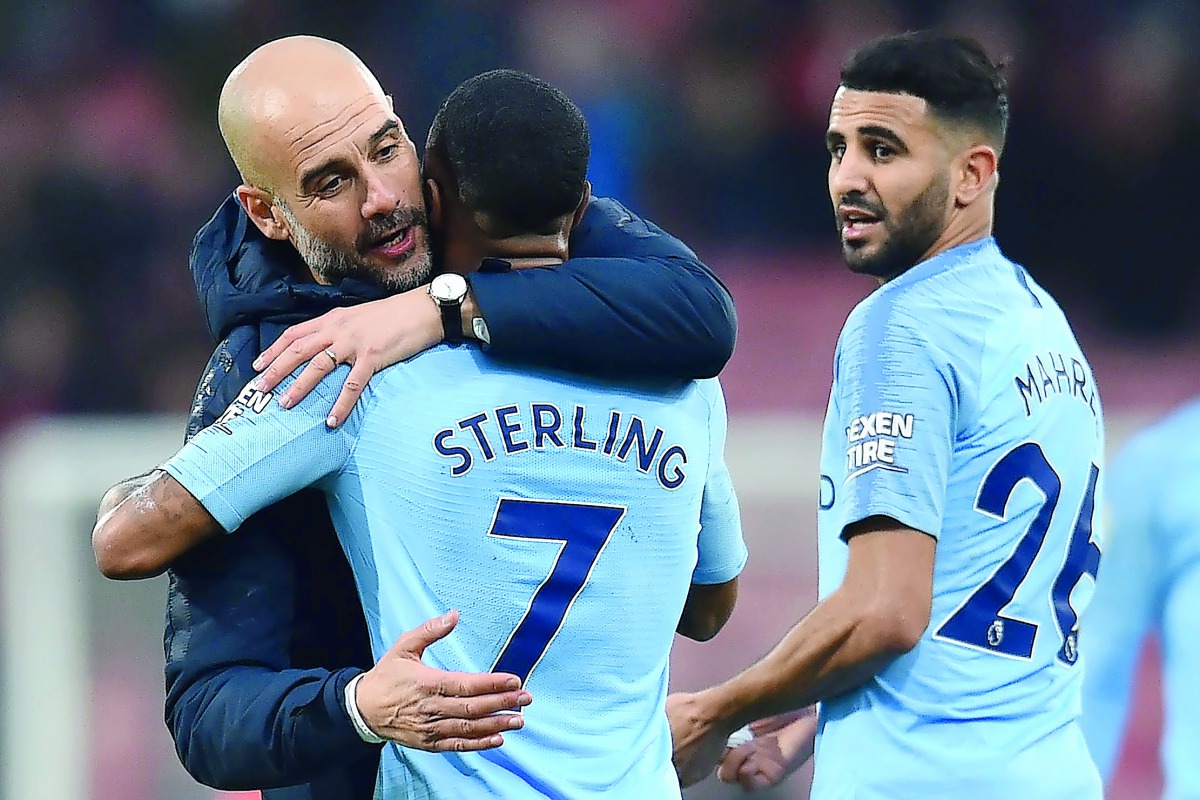 Manchester City's Spanish manager Pep Guardiola (L) hugs Manchester City's English midfielder Raheem Sterling agter the English Premier League football match between Bournemouth and Manchester City at the Vitality Stadium in Bournemouth, southern England 
