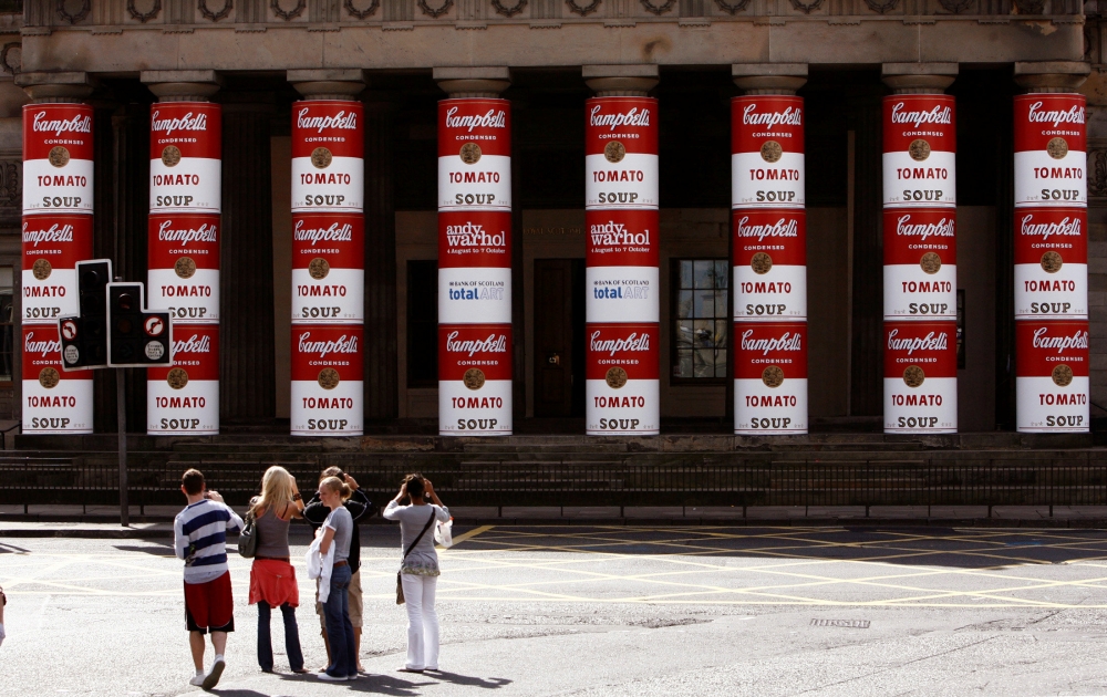 Members of the public look at the main pillars of the National Gallery of Scotland complex, that were unveiled to show an Andy Warhol 'Campbell's Soup cans' artwork covering, in Edinburgh, Scotland July 31, 2007. Reuters/David Moir