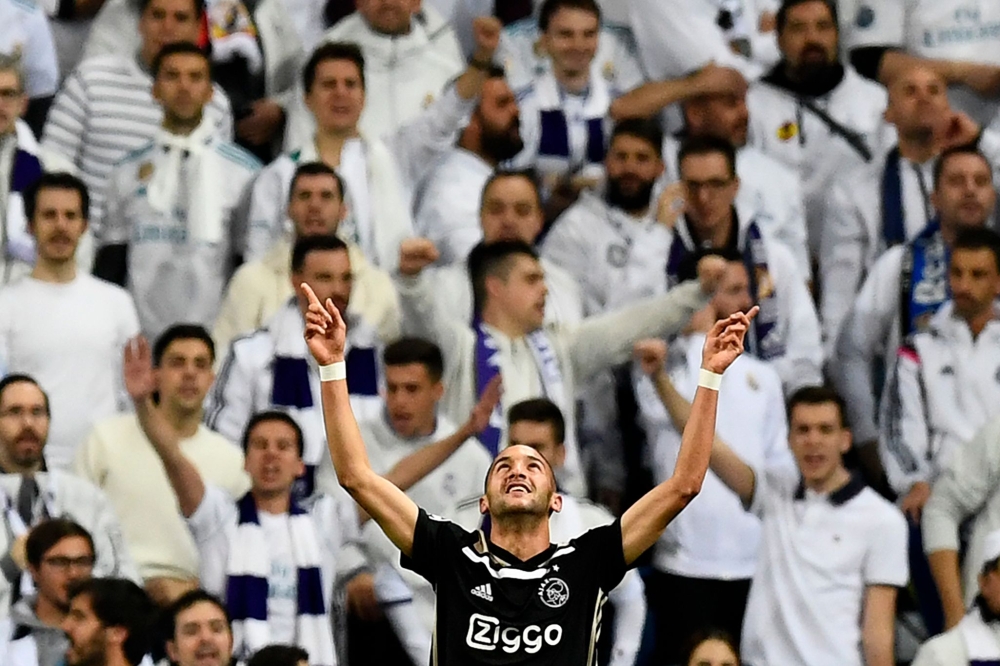 Ajax's Moroccan midfielder Hakim Ziyech celebrates after scoring a goal during the UEFA Champions League round of 16 second leg football match between Real Madrid CF and Ajax at the Santiago Bernabeu stadium in Madrid on March 5, 2019.  AFP / Gabriel Bouy