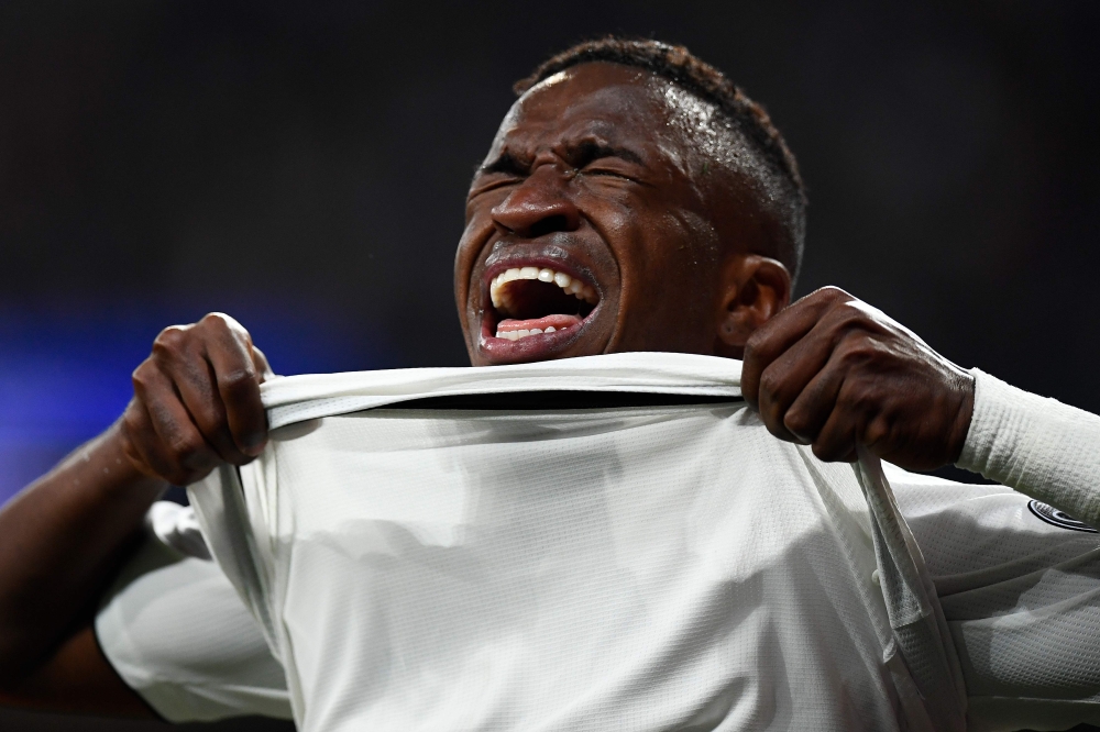 Real Madrid's Brazilian forward Vinicius Junior reacts as he walks off the pitch after getting injured during the UEFA Champions League round of 16 second leg football match between Real Madrid CF and Ajax at the Santiago Bernabeu stadium in Madrid on Mar